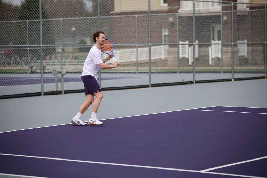 Tennis player hitting ball