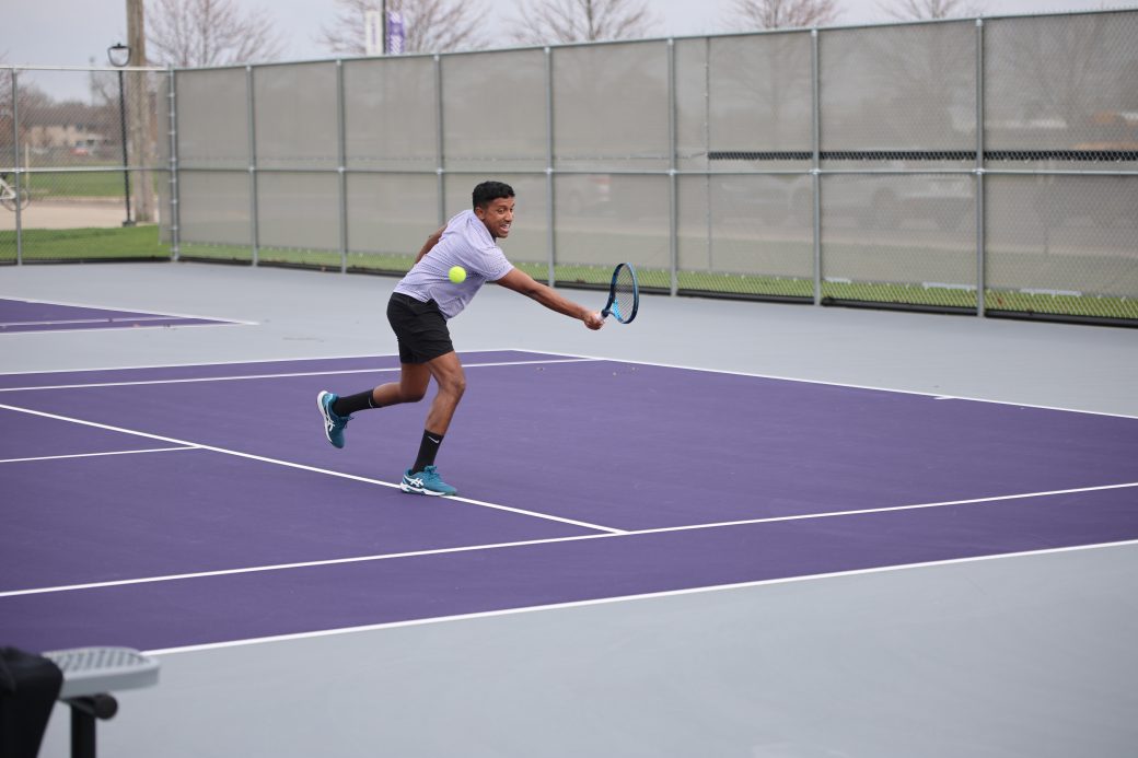 Tennis player hitting ball