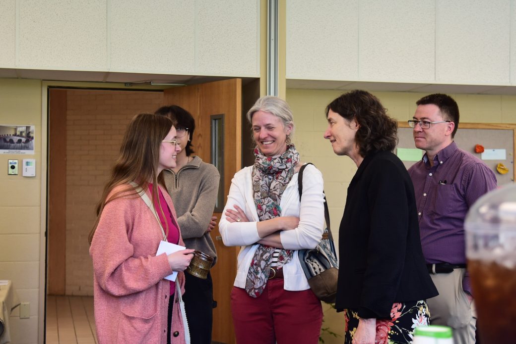 Faculty and staff in deep conversation