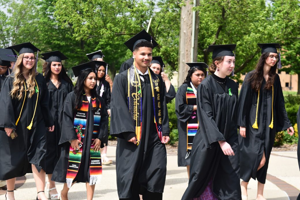 Male graduate walking Roman Gingerich Recreation-Fitness Center