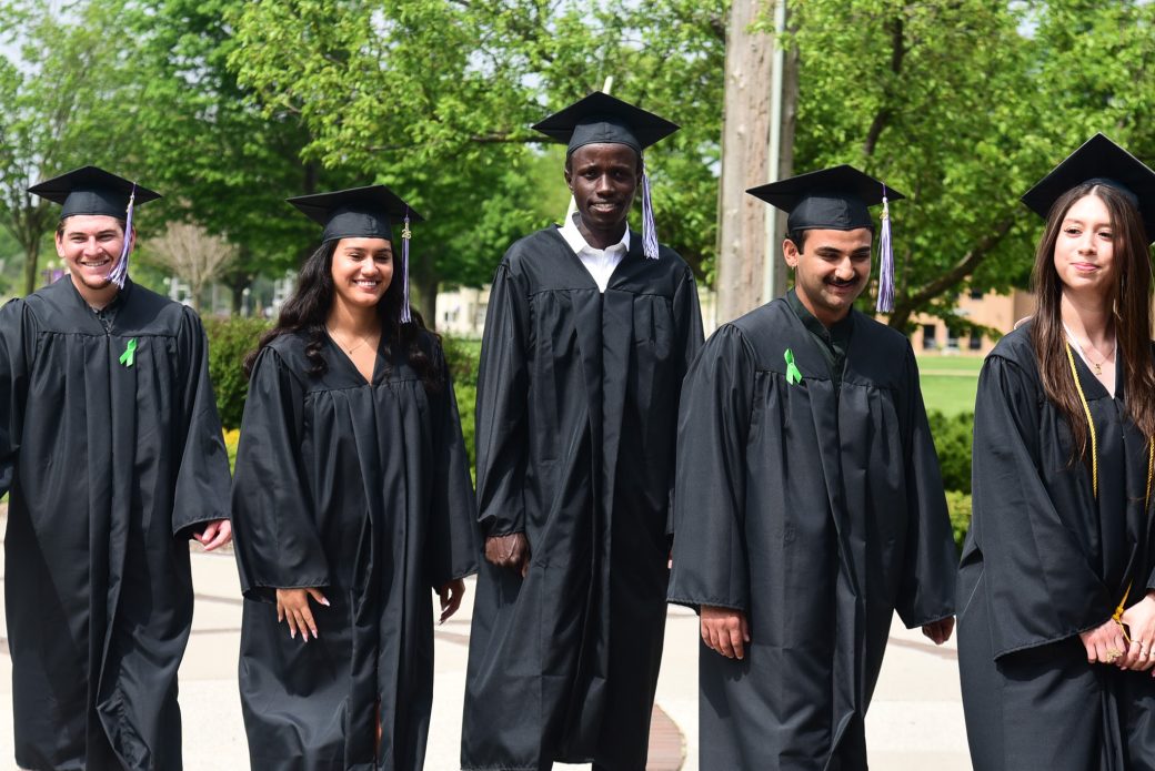 Group of three graduates heading into Roman Gingerich Recreation-Fitness Center