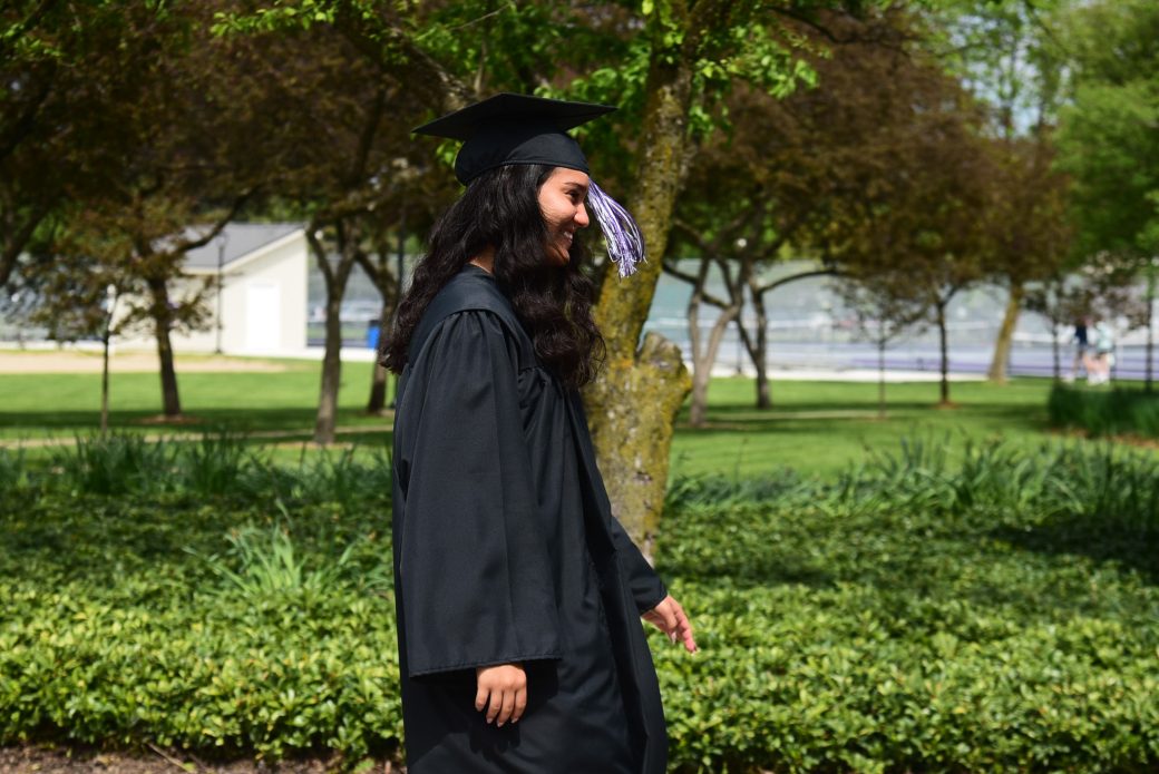 Close up of female graduate walking