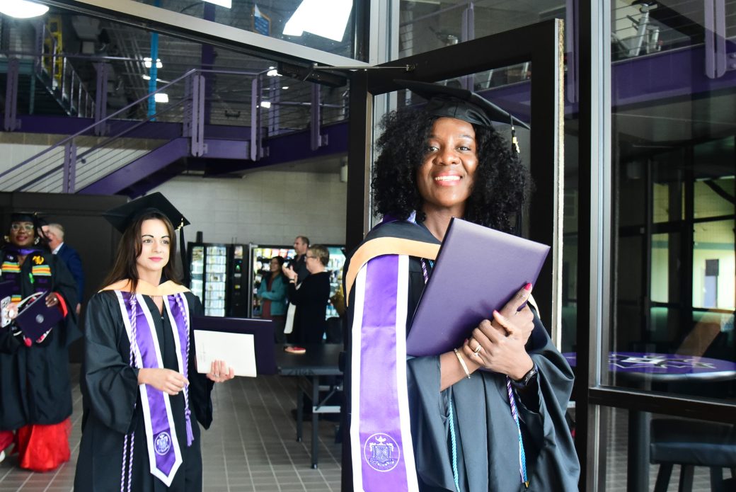 Graduates passing through doorway as they exit ceremony