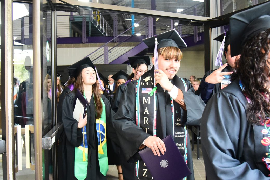 Graduates exiting through doorway at end of ceremony