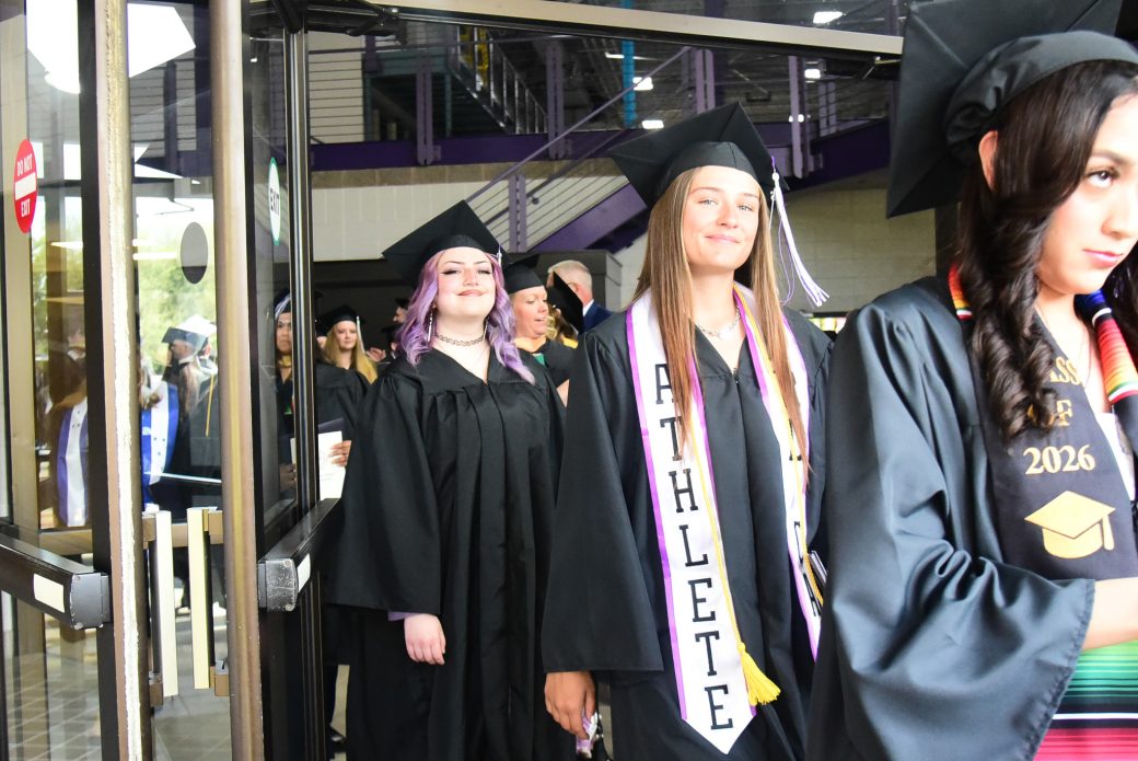 Students moving through doorway as they leave graduation ceremony