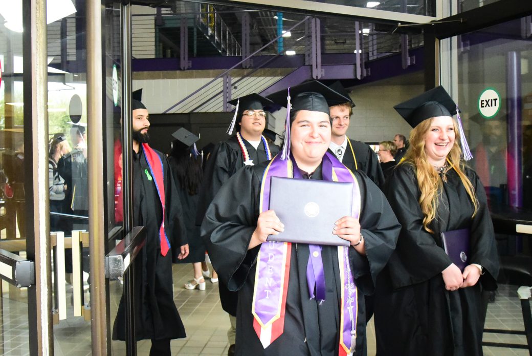 Students walking through doorway to exit ceremony space