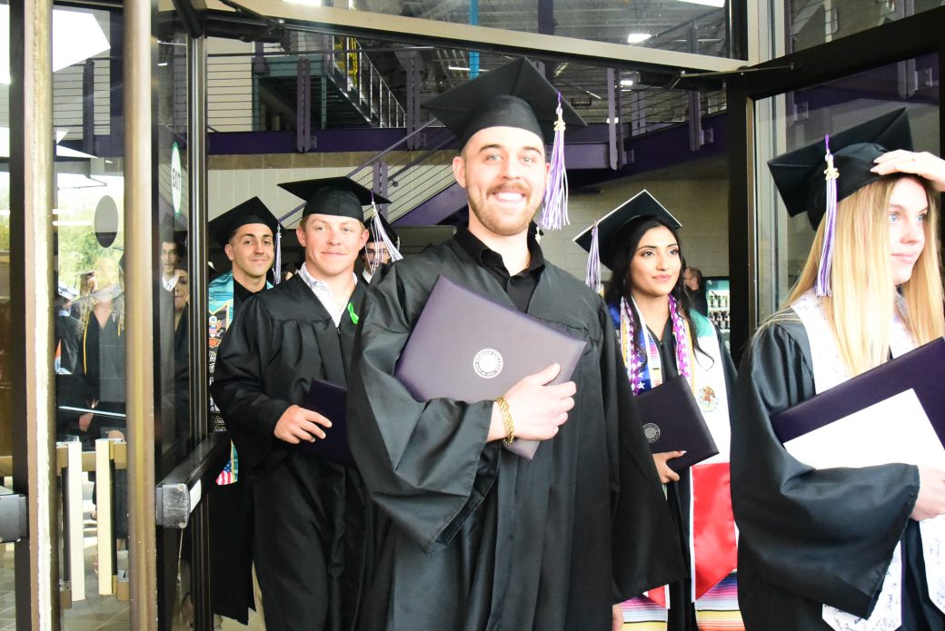 Students exiting through doorway following commencement