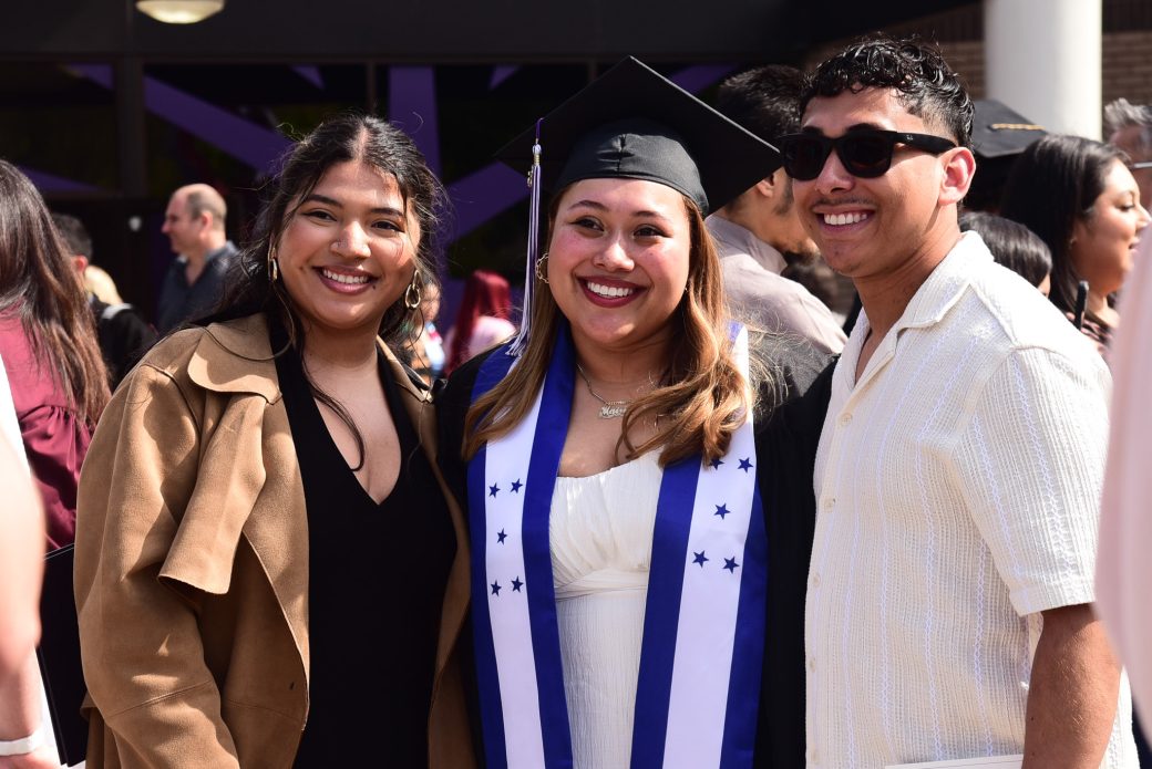Graduate posed with friends outside