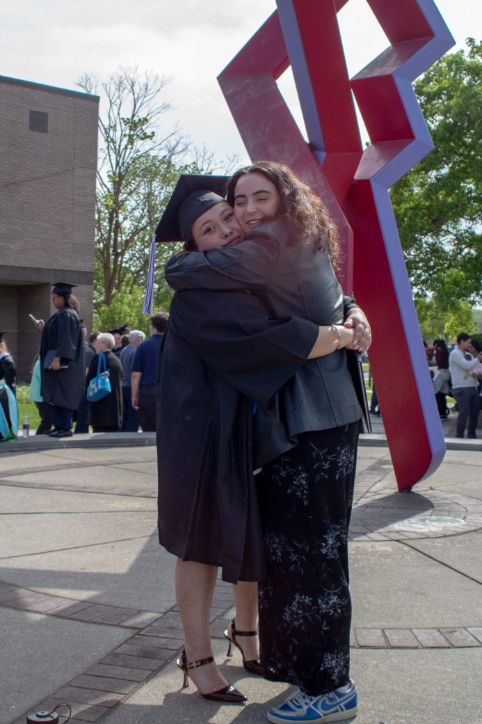 Graduate embracing family