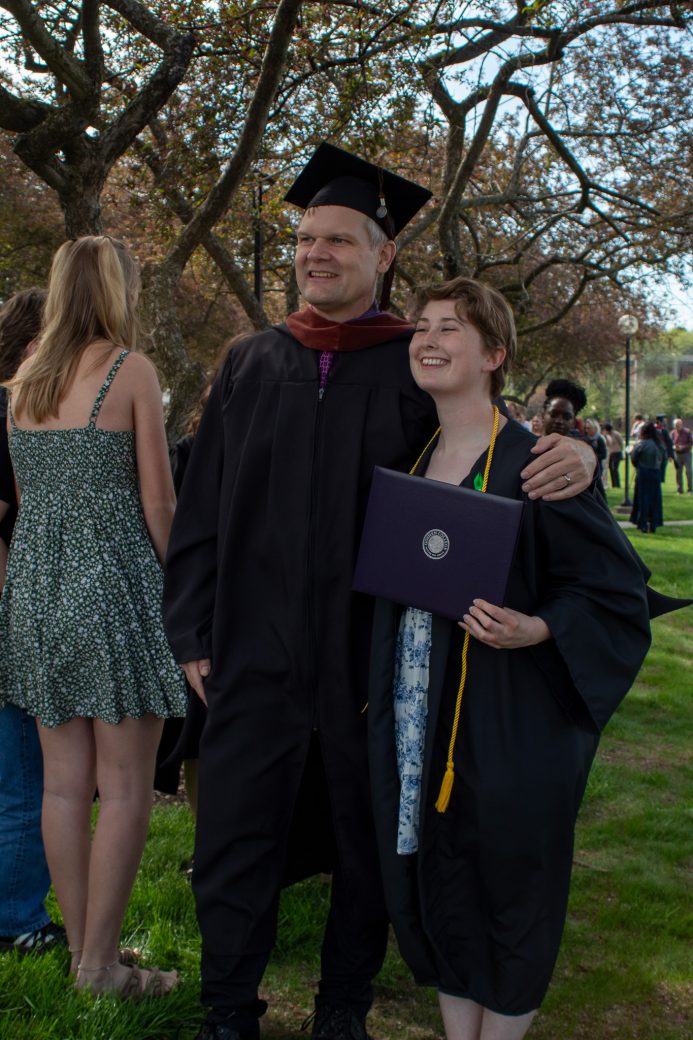 Kate Bodiker celebrating with faculty member outside