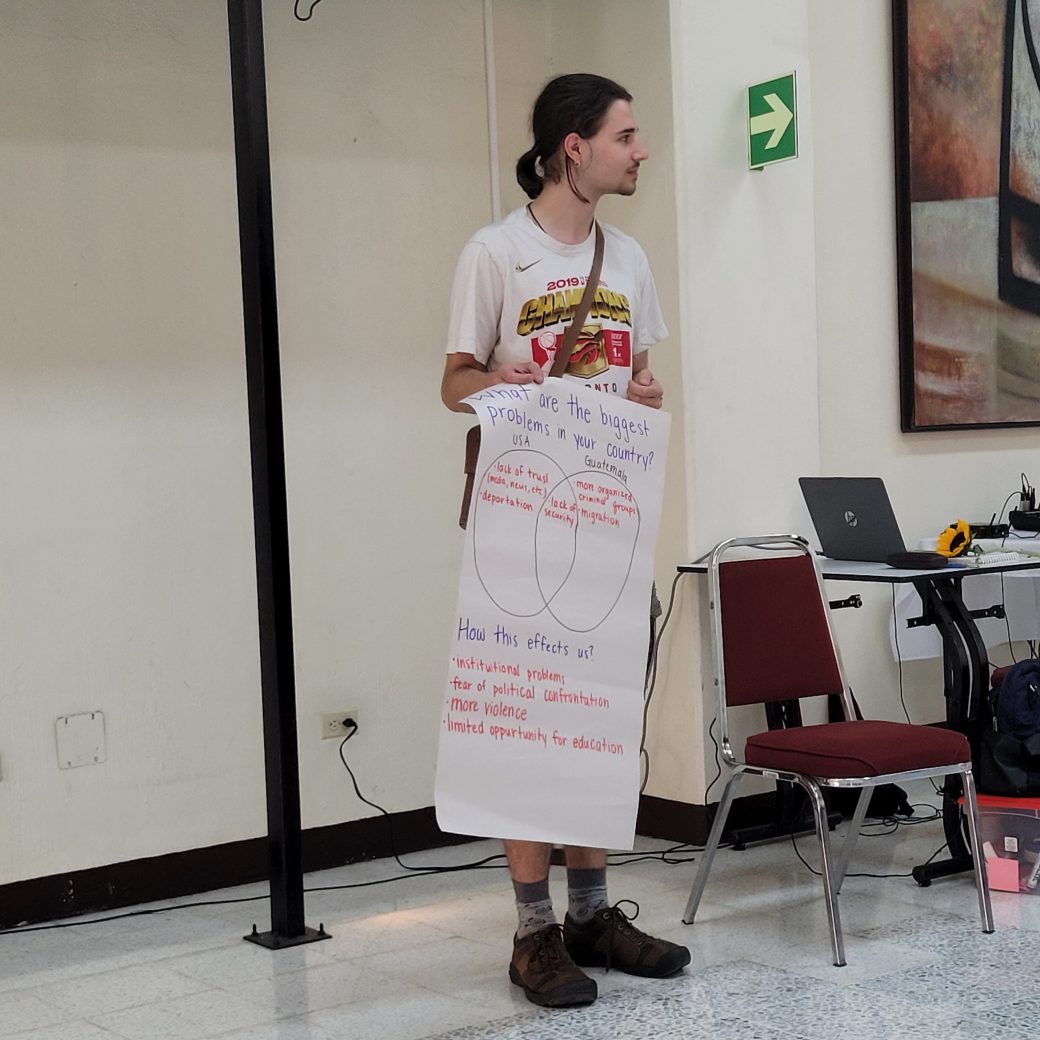 A person holding a large paper with handwritten notes.