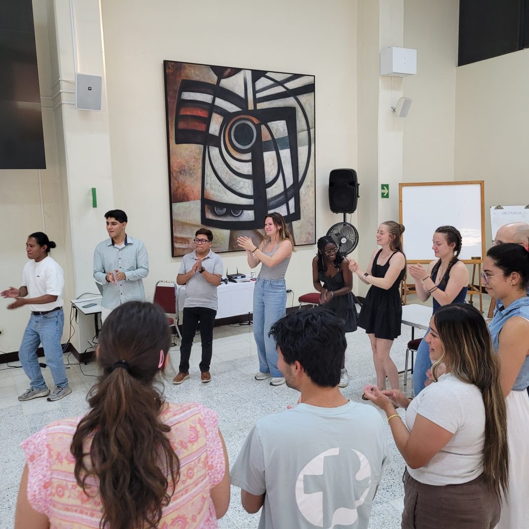 A large group of young people, standing in a circle.
