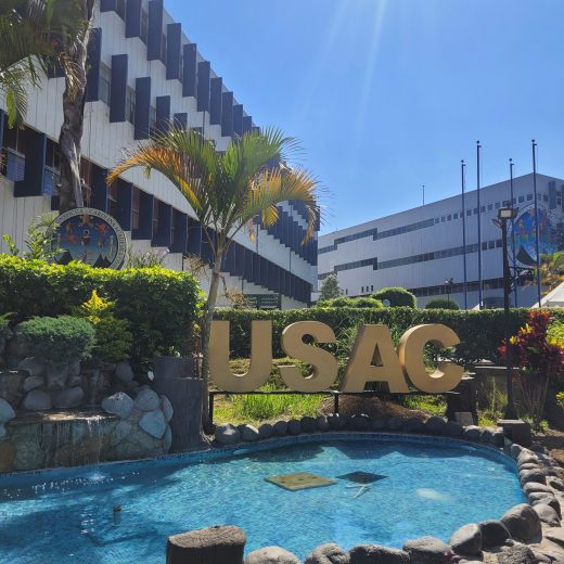 A decorative pool in the middle of a university campus, surrounded by tall buildings.