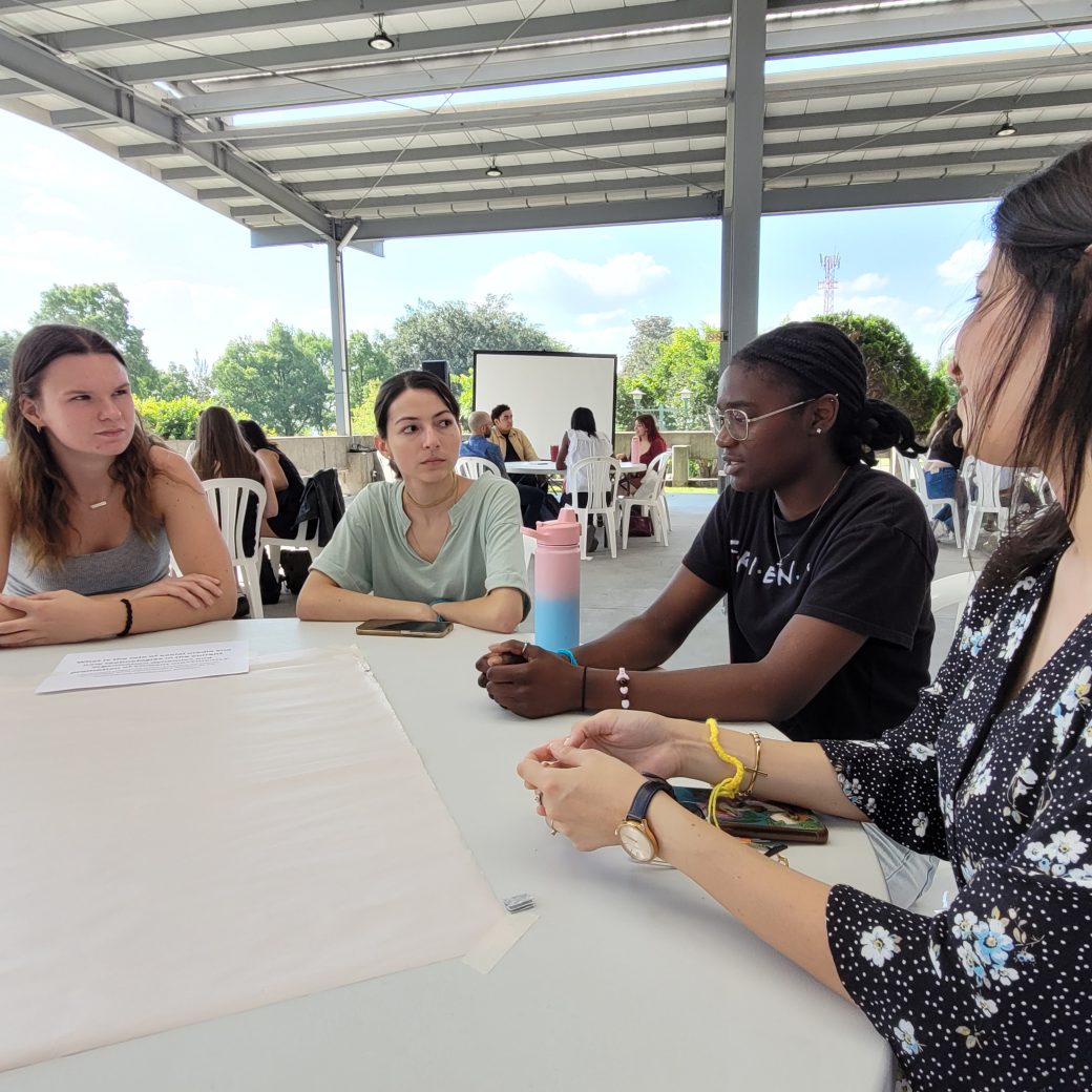 A group of people talking at a table.