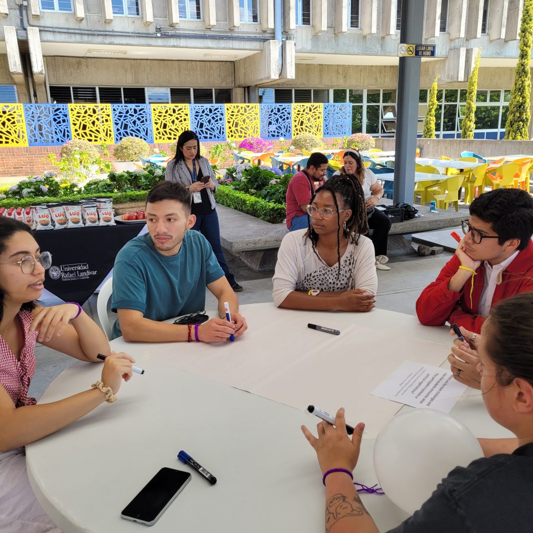 A group of people talking at a table.