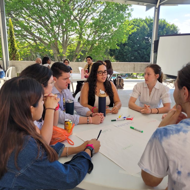 A group of people talking at a table.