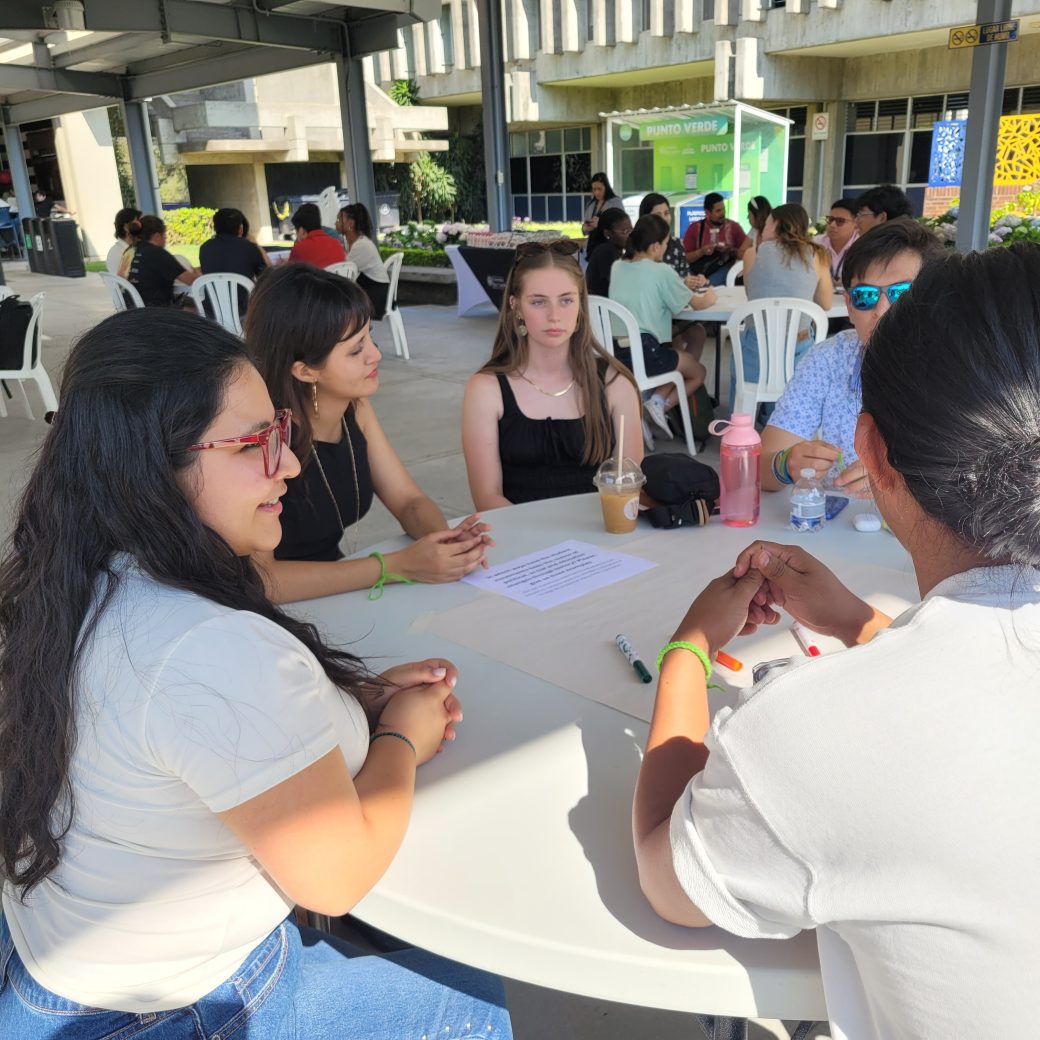 A group of people talking at a table.