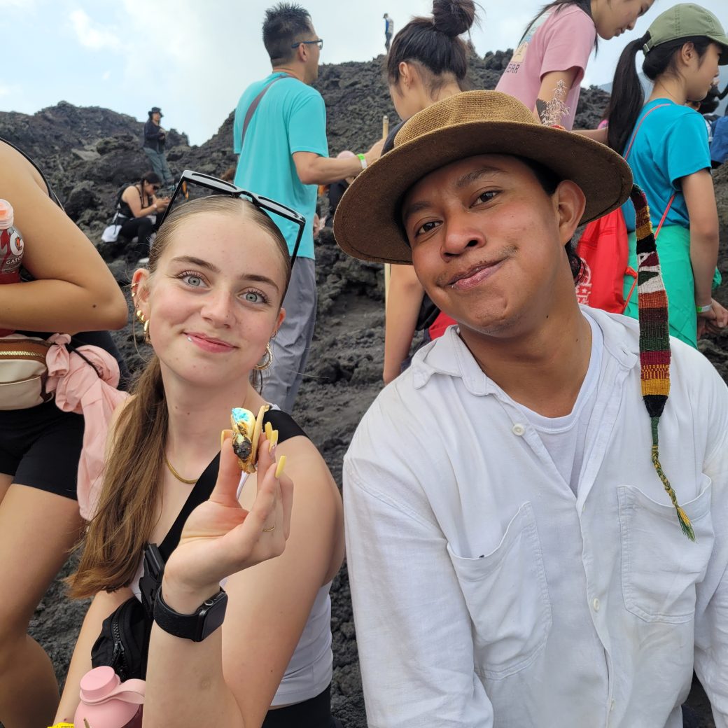 Two people pose with s'mores.
