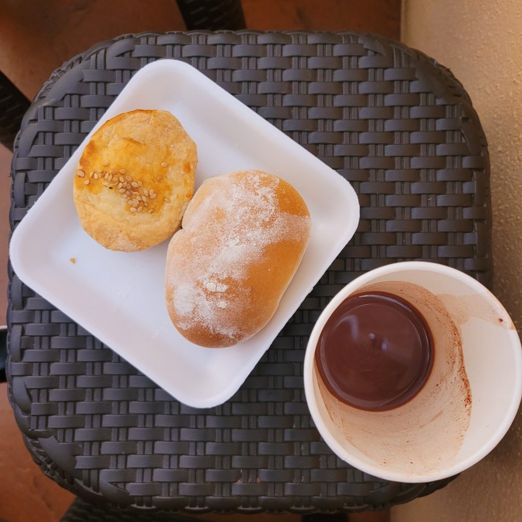 A cup and dish with food and drink.