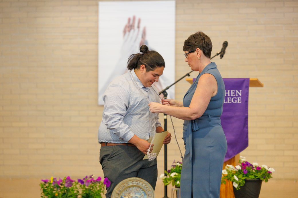 Jewel Yoder giving student cord