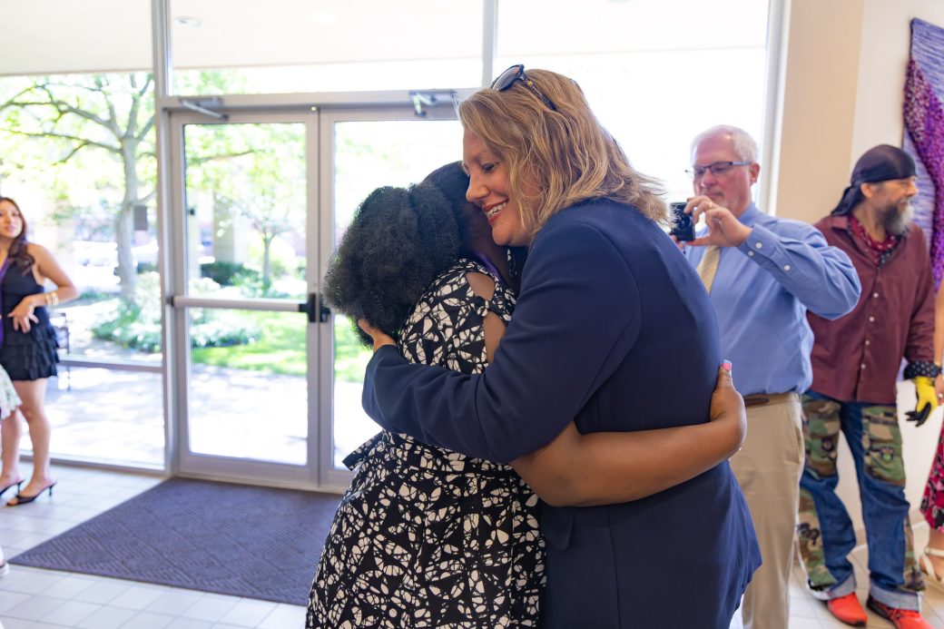 MSN graduate hugging friend