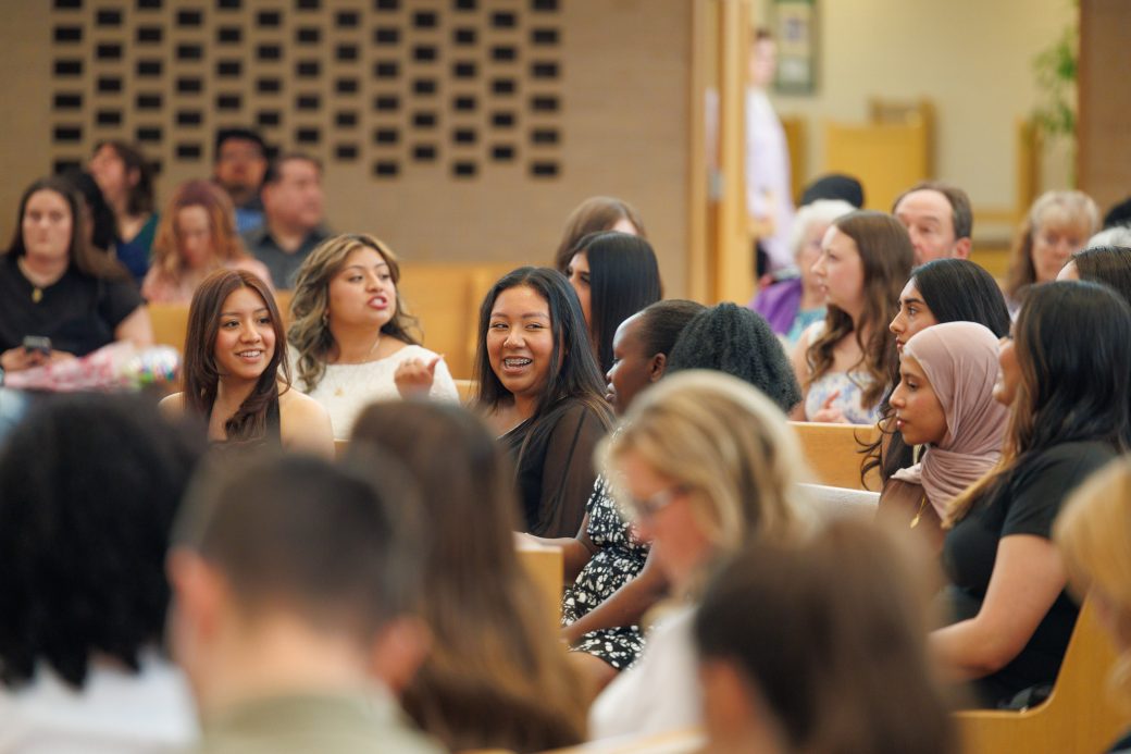 Students laugh and smile in the audience