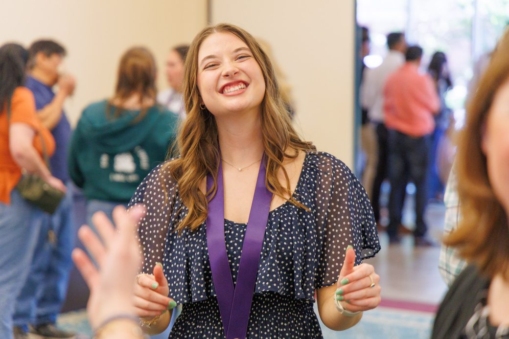 Nursing grad smiling giving thumbs up