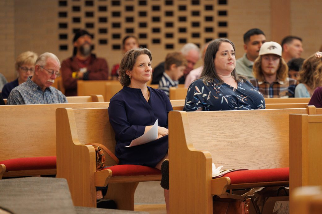 Faculty and staff sit in audience of Nurse Pinning Ceremony