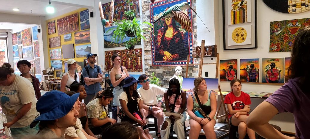 A group of people seated and surrounded by art.