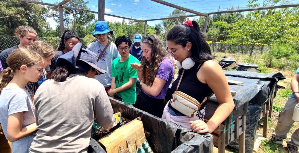A group of people gathered around a large wooden box.