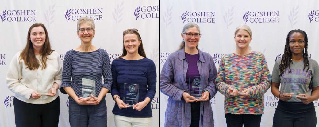 2026 employee awardees standing in a line holding their respective awards in front of a backdrop of the Goshen College seal