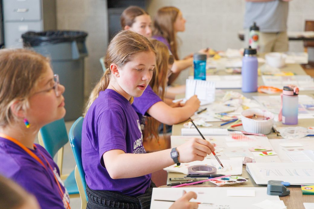 Junior high student painting trading cards