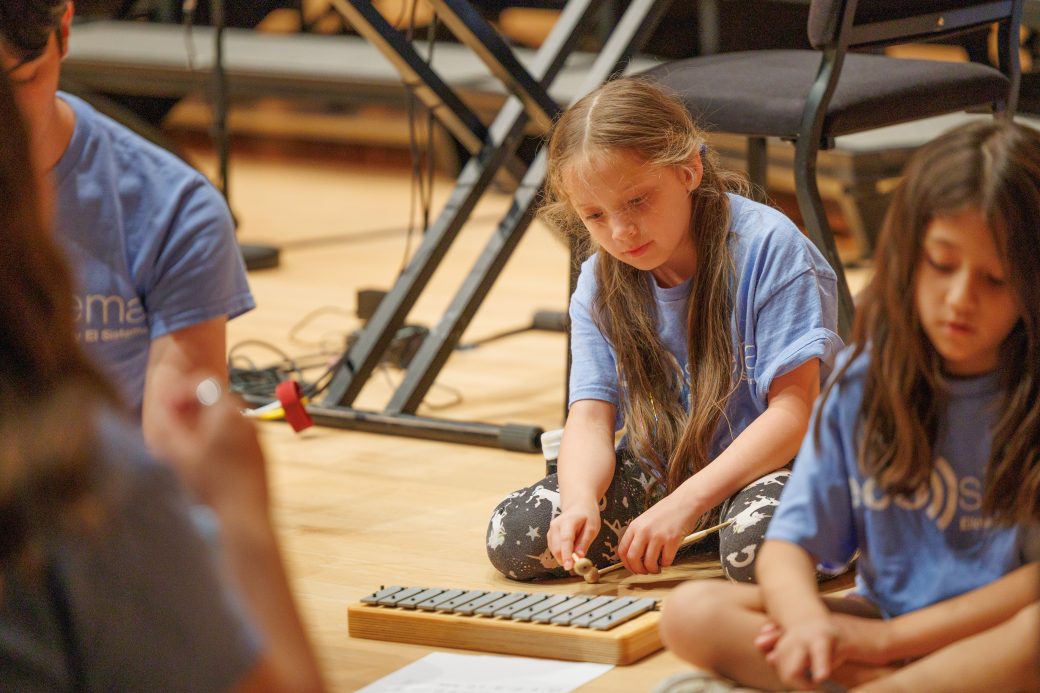 Close up of student playing instrument