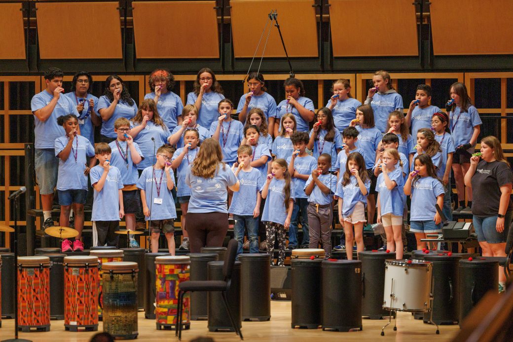 Group of choir students playing kazoos