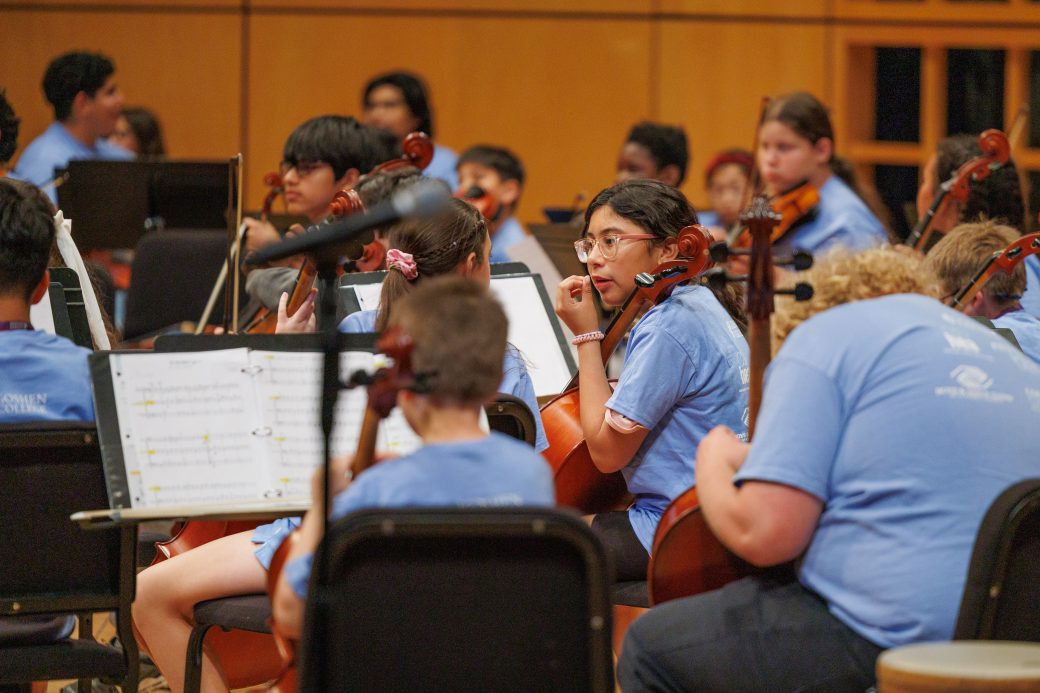 Two students talking during orchestra performance