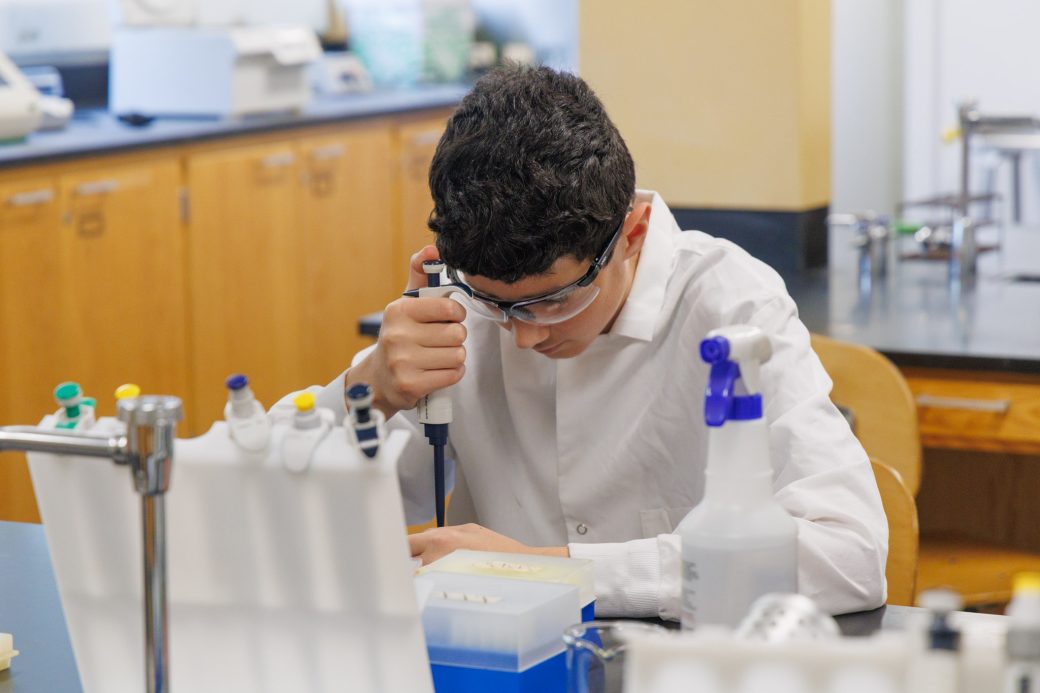 Student in lab working on project at science camp