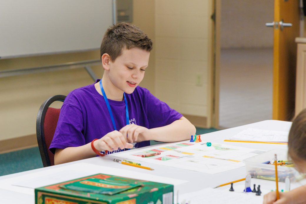 Summer camper working on board game project