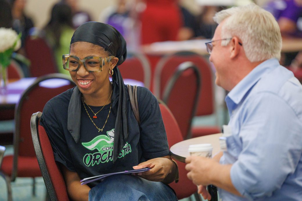Academic advisor is making new incoming student laugh