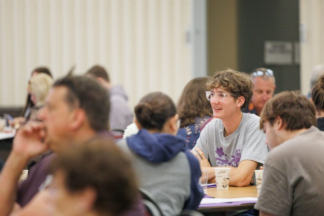 Student at table with family for new student orientation