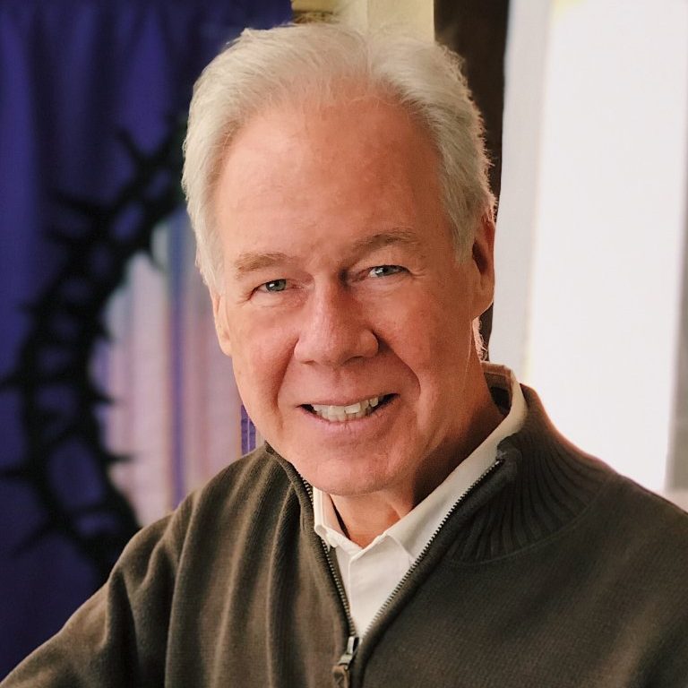 headshot of martin doblmeier in a brown shirt and blurred background