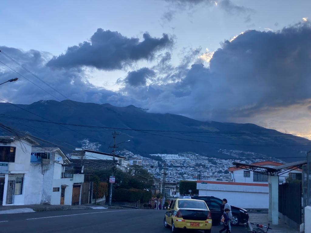 Dramatic clouds over dark mountains at dusk.