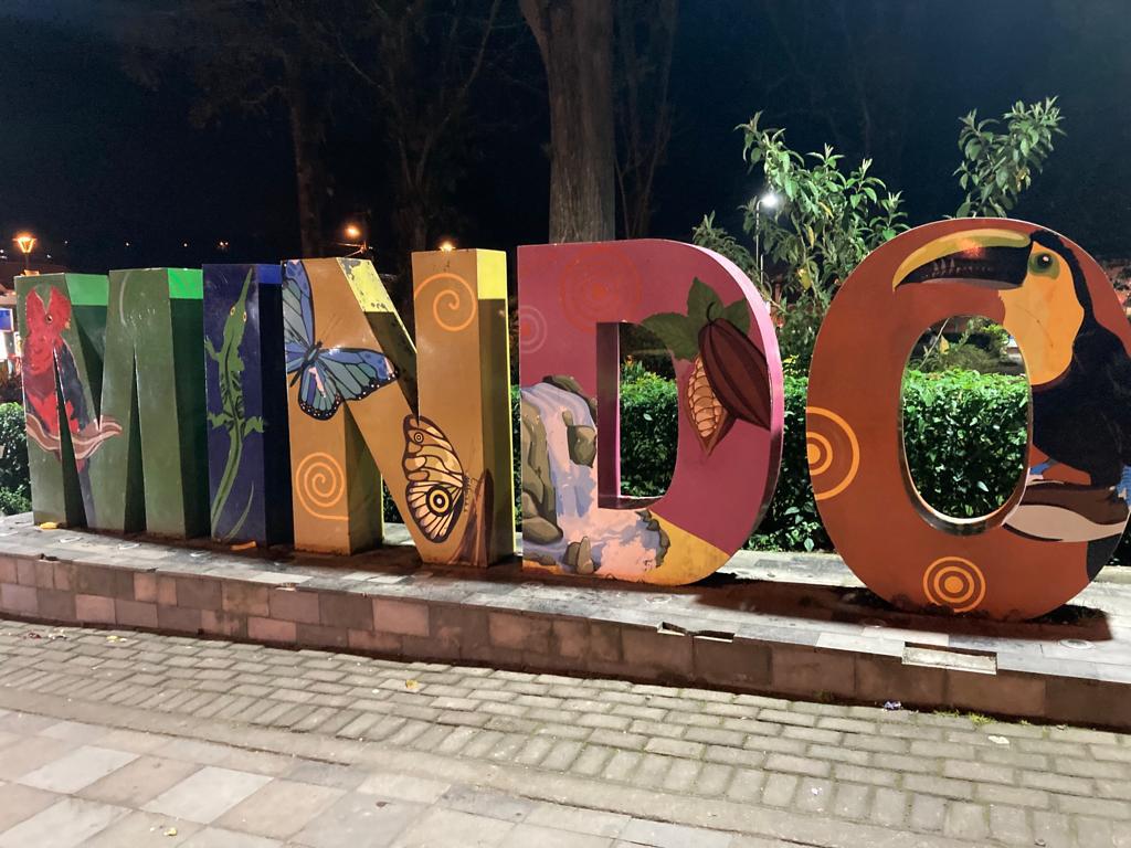Large colorful letters spelling a place name displayed outdoors at night.