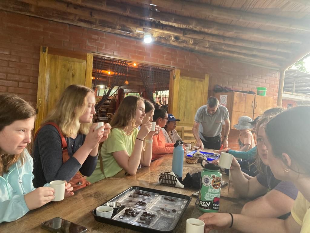 Students seated at a table doing a tasting activity together.