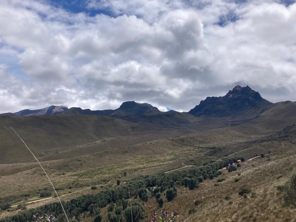 A rugged volcanic peak rising above highland terrain.
