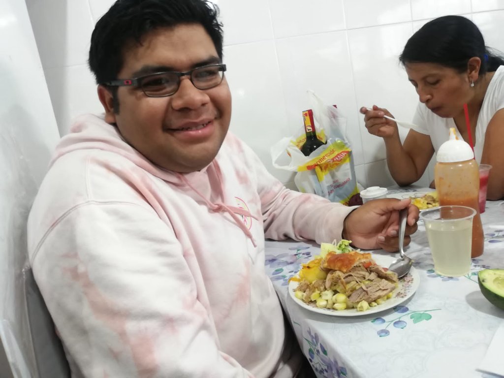 A student sharing a home-cooked meal with a host family member.
