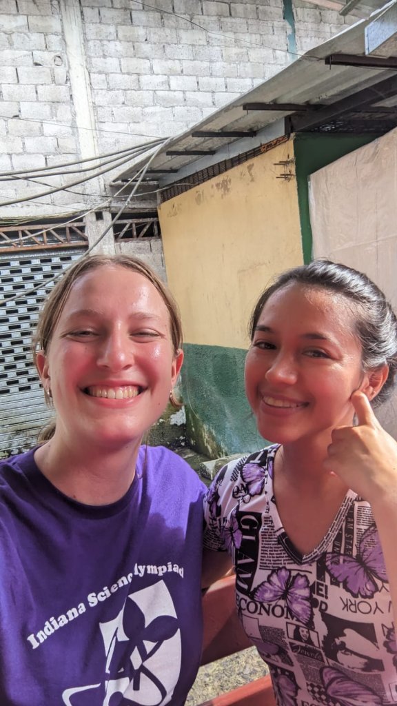 A student smiling in a selfie with a host family member.
