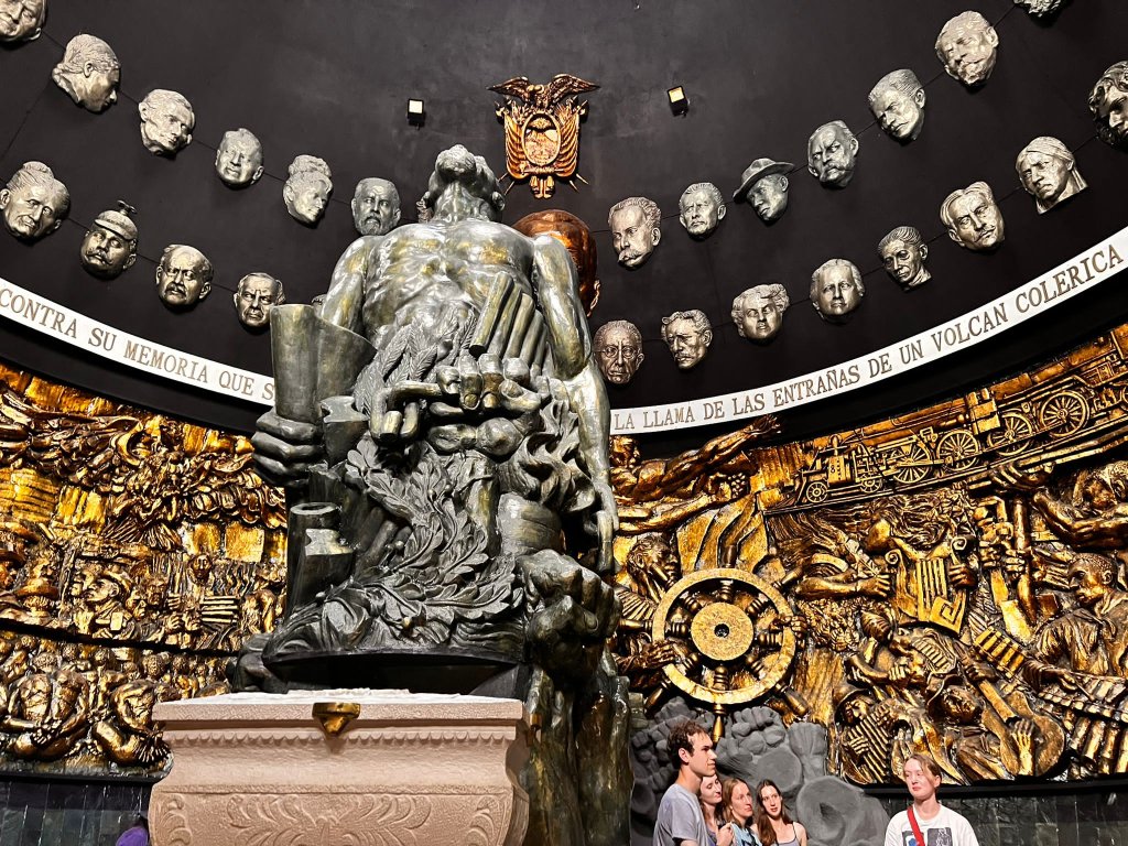 An elaborate gilded altar with sculpted faces surrounding a central figure.
