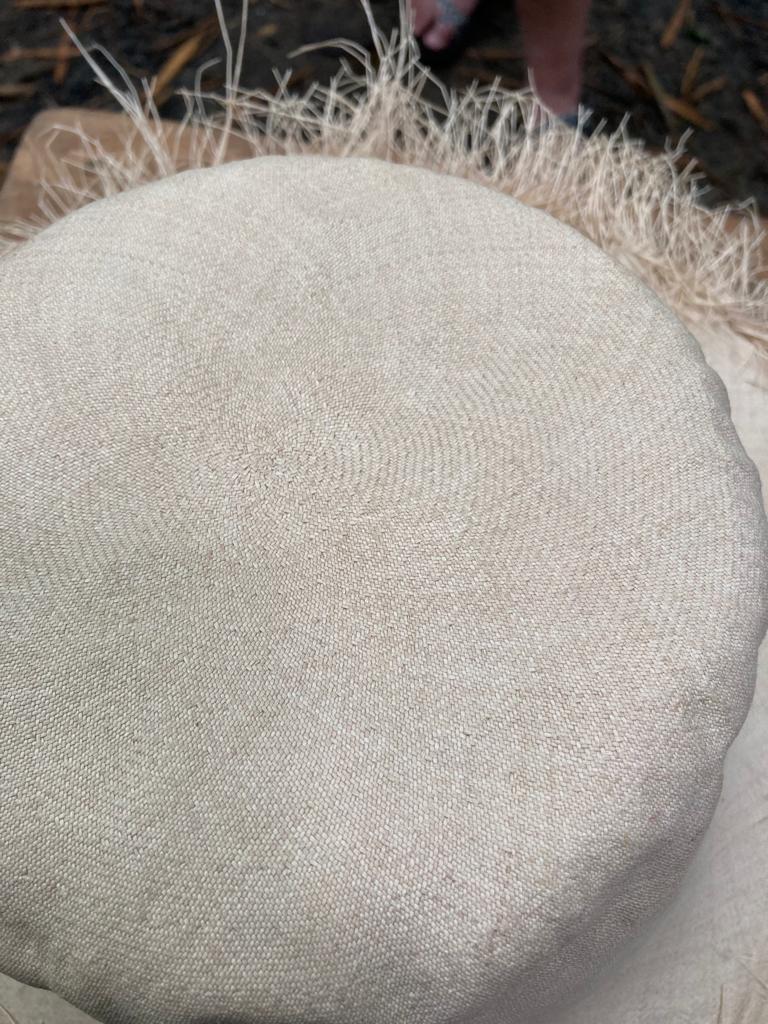 A close-up of the crown of a woven straw Panama hat.
