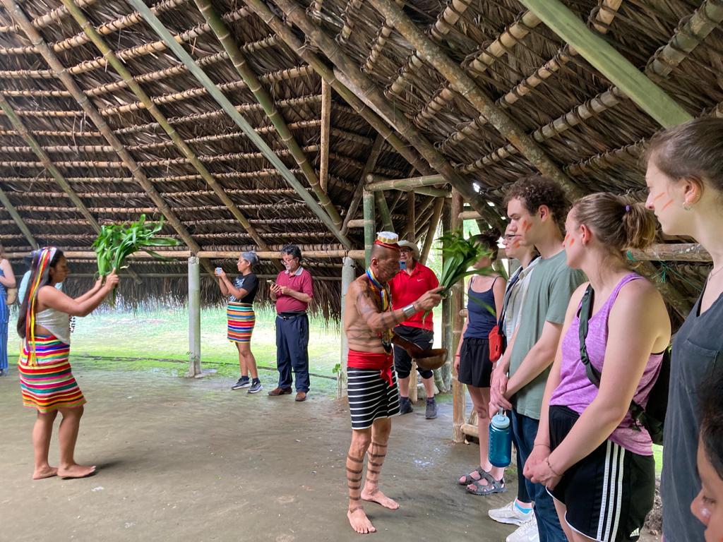 A performer engaging with students beside the ceremonial space.
