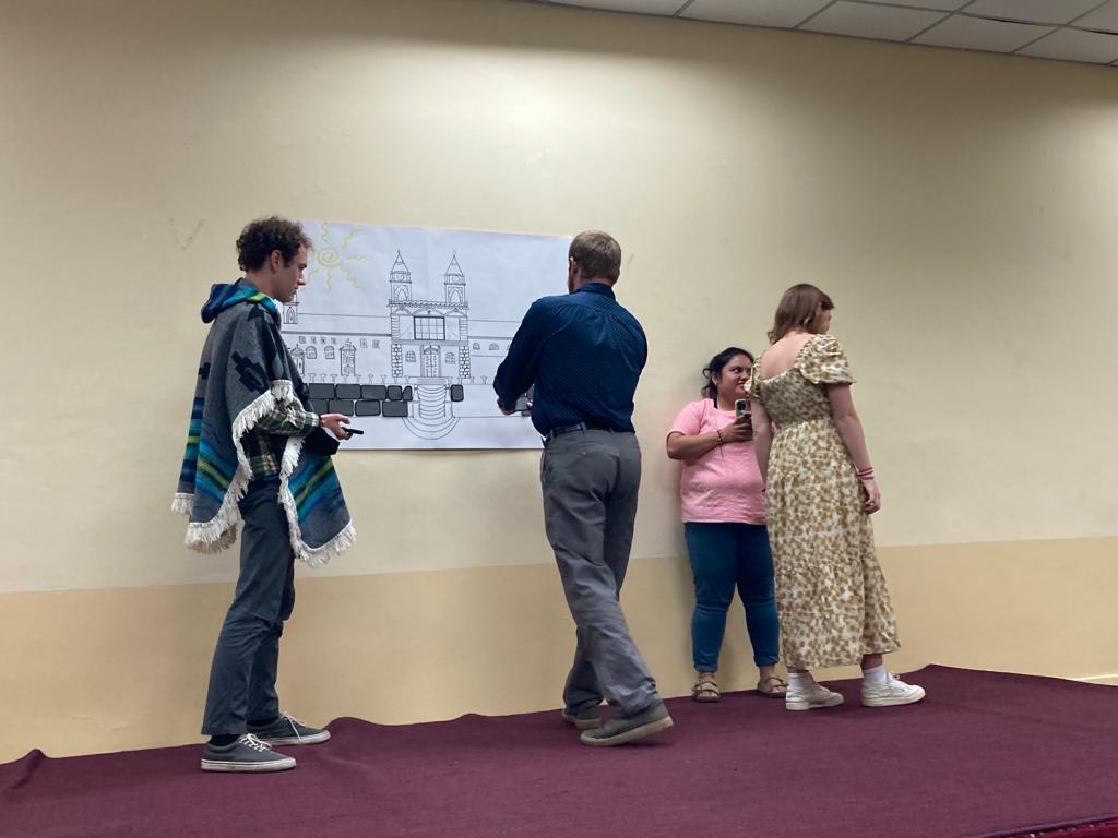 Students dramatizing a scene together on stage.
